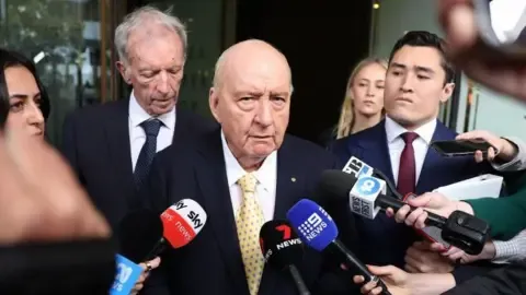 Sex Abuse Charges Against Leading Down Under Media Personality Downgraded